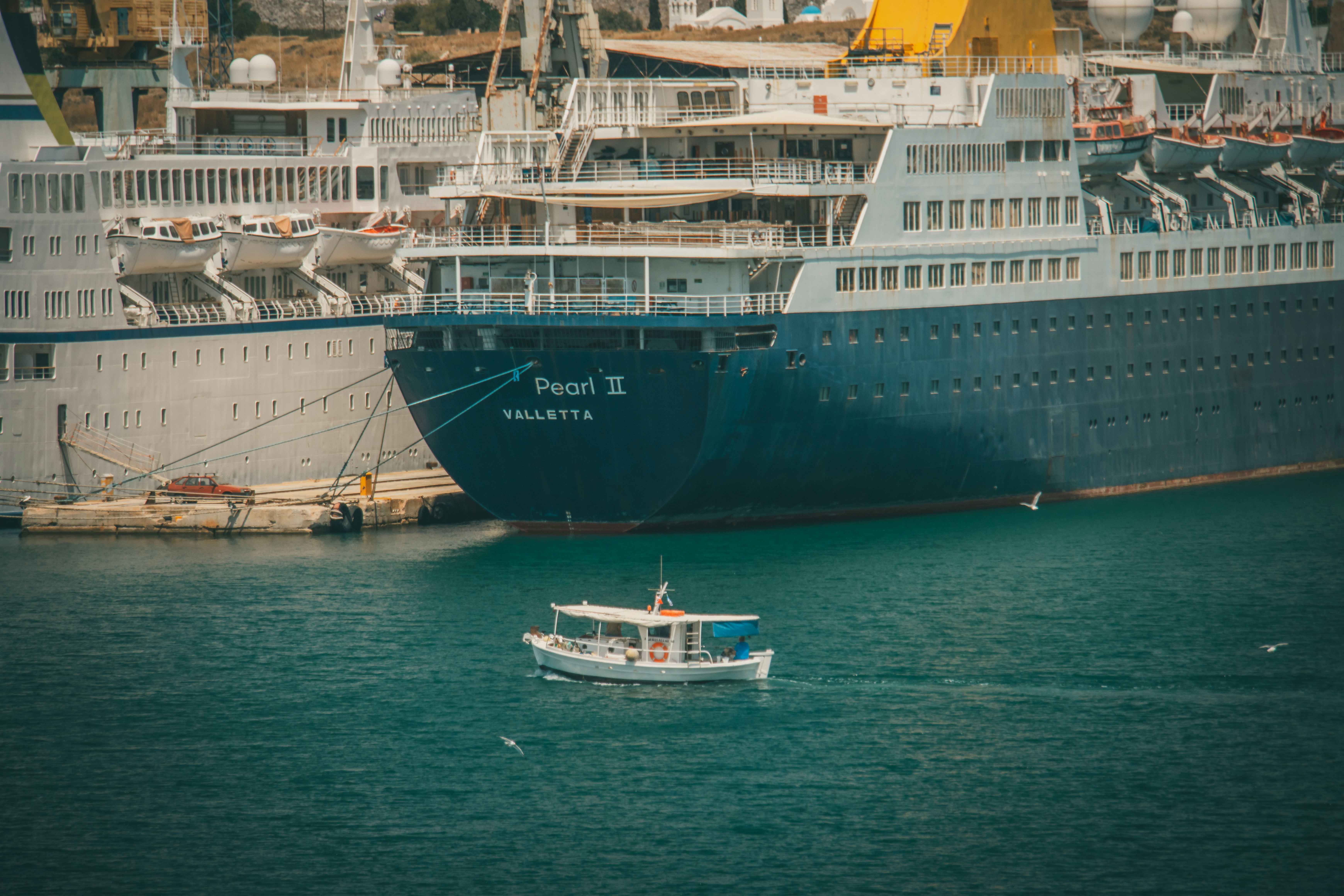 blue and white ship on sea during daytime